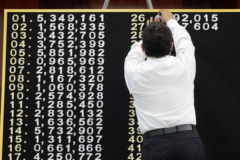 A man puts winning numbers on the board during a
