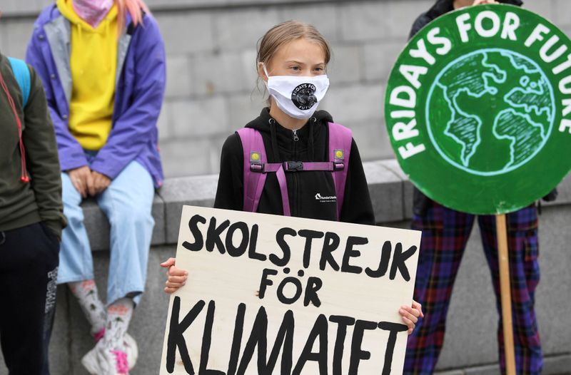 FILE PHOTO: Swedish climate activist Greta Thunberg holds a poster
