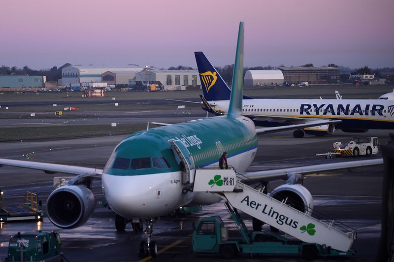 FILE PHOTO: Passengers disembark from Aer Lingus and Ryanair aircraft