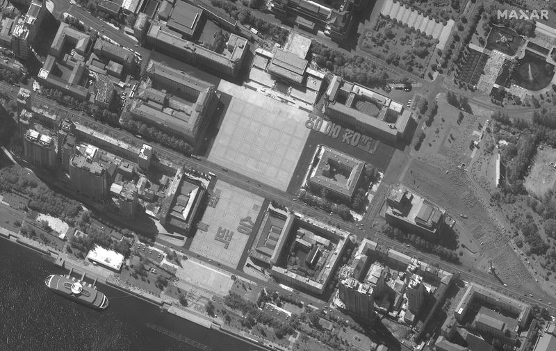 A satellite image shows an overview of people assembled in