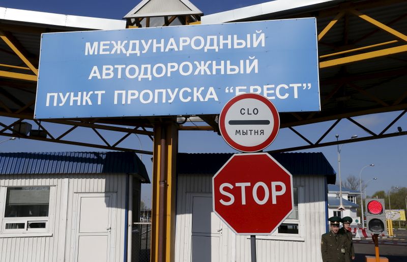 Belarussian border guards stand at a border crossing between Belarus