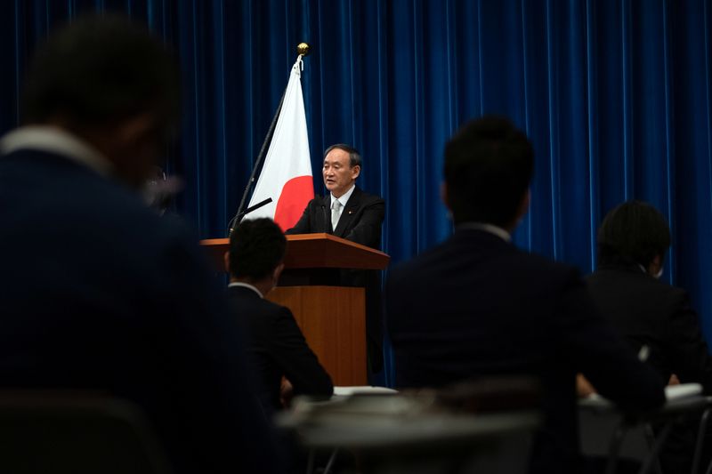 Yoshihide Suga speaks during a news conference following his confirmation