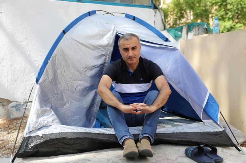 Omid Tootian, an Iranian musician, sits in a tent inside
