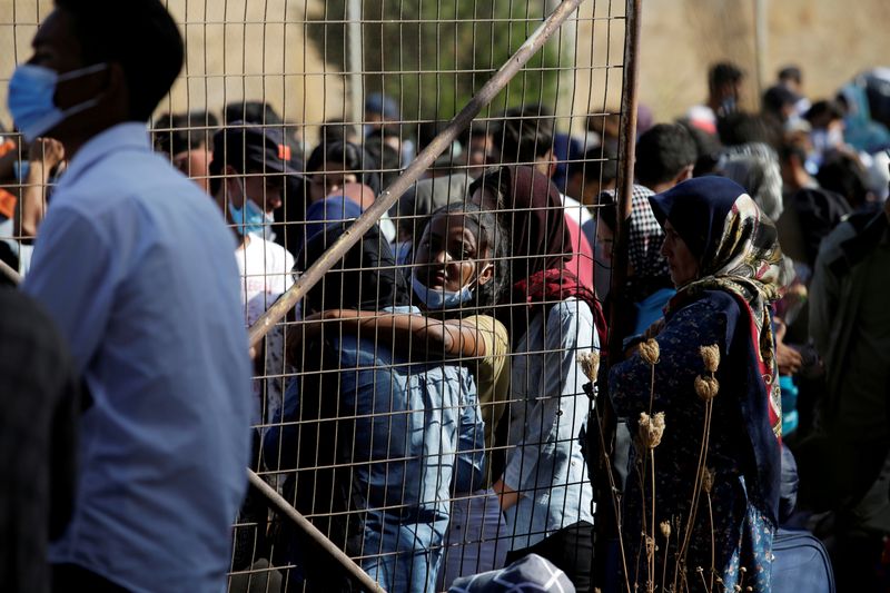 FILE PHOTO: Refugees and migrants from the destroyed Moria camp