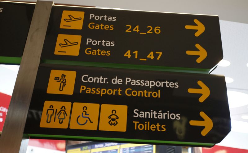 FILE PHOTO: Gates, passport control and toilets signs are seen