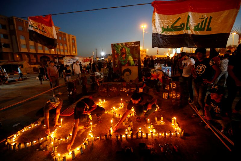 Iraqis march in Najaf on the anniversary of the anti-government