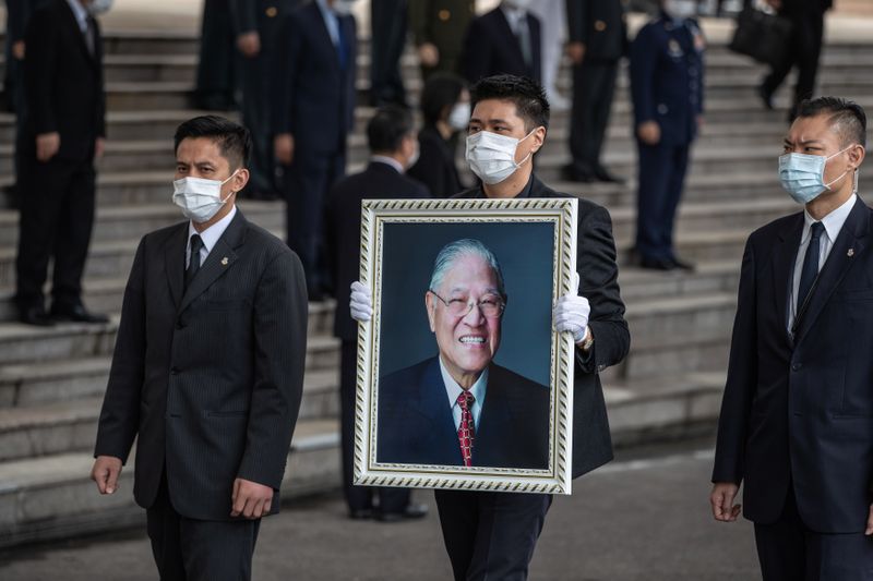 Man holds a portrait of former Taiwan President Lee Teng-hui