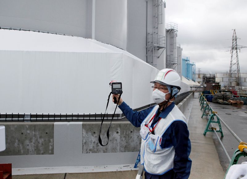 FILE PHOTO: A Tokyo Electric Power Co (TEPCO) employee uses