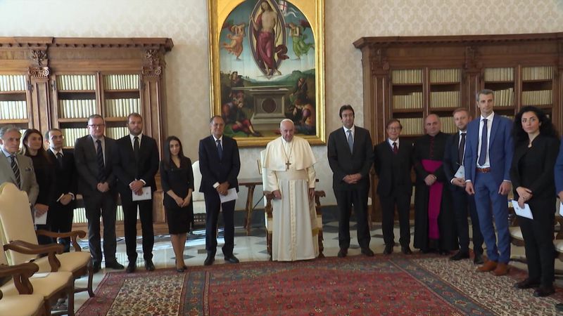 Pope Francis poses with experts of Moneyval at the Vatican