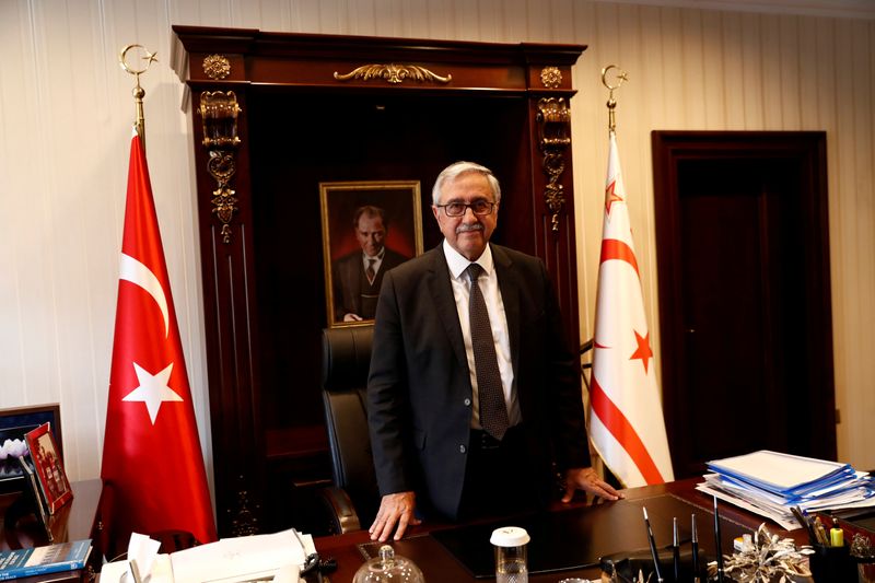 FILE PHOTO: Turkish Cypriot leader Akinci poses at his office