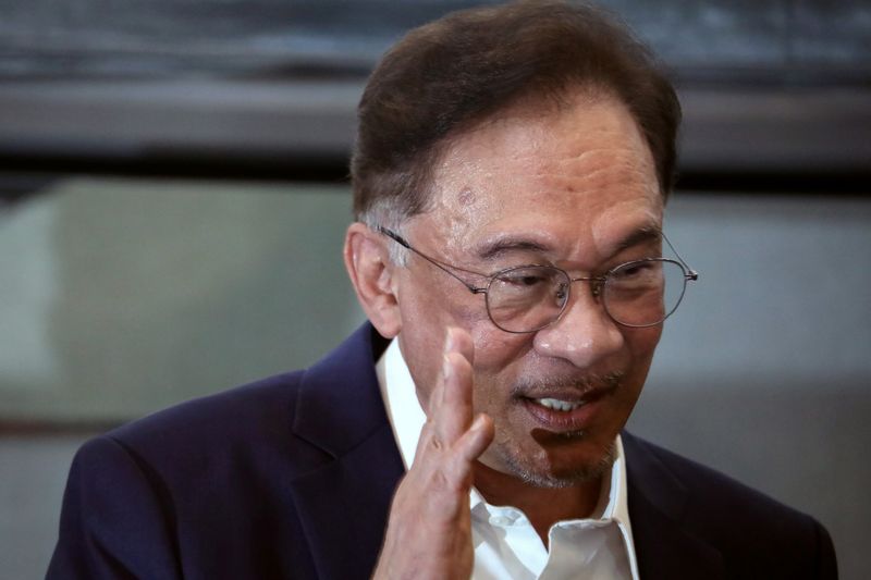 FILE PHOTO: Malaysia opposition leader Anwar Ibrahim waves after a
