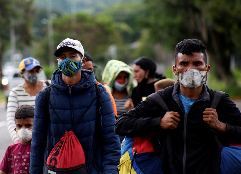 Venezuelan migrants walk towards the border between Venezuela and Colombia