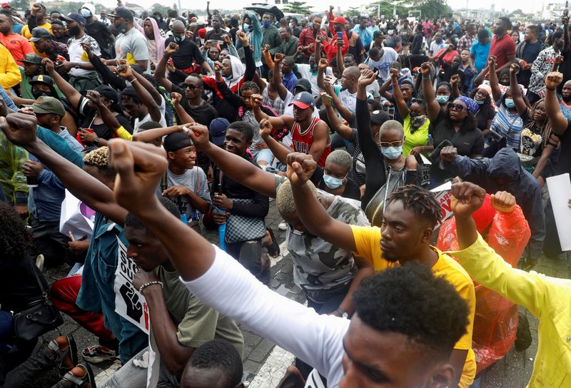 FILE PHOTO: Demonstrators gesture during a protest over alleged police
