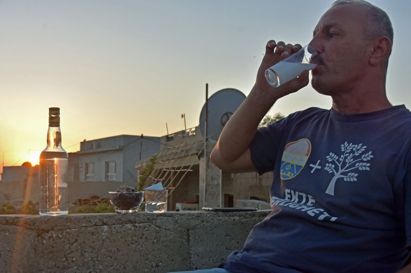 Saad Hussein, an Iraqi Yazidi, drinks Arak that he produces