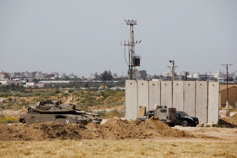 FILE PHOTO: An Israeli tank and a military vehicle can
