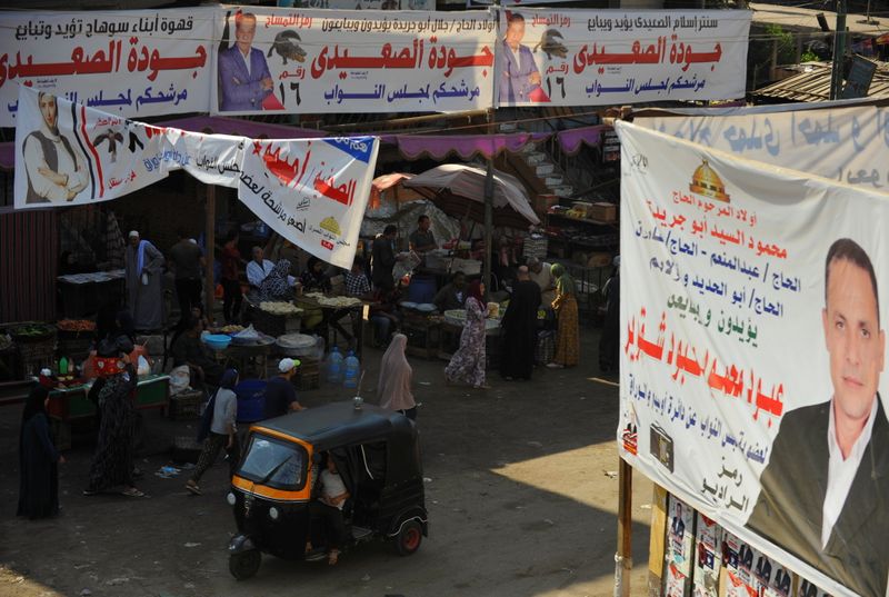 Campaign banners of candidates are seen in a street market
