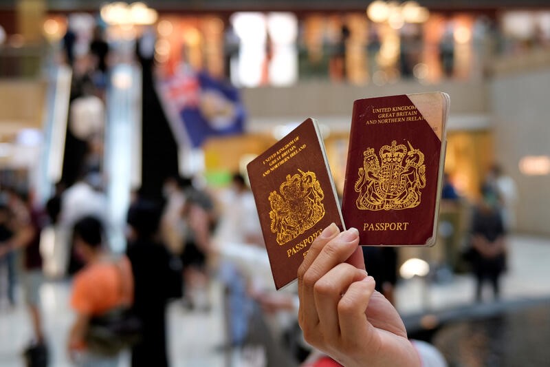 A pro-democracy demonstrator holds British National Overseas (BNO) passports during