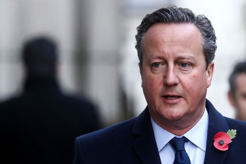 Britain’s former Prime Minister David Cameron arrives to attend the
