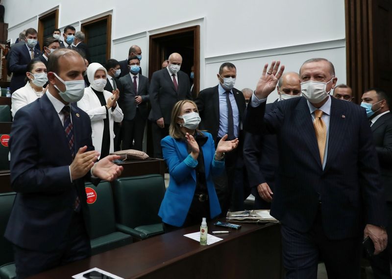 Turkish President Erdogan greets members of his ruling AKP during
