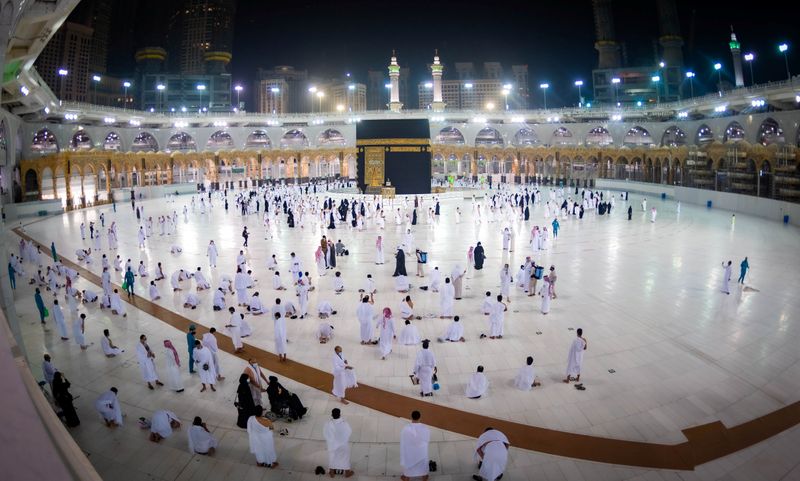 Muslims, keeping a safe social distance, perform Umrah at the