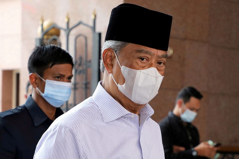 Malaysia’s Prime Minister Muhyiddin Yassin wearing a protective mask arrives
