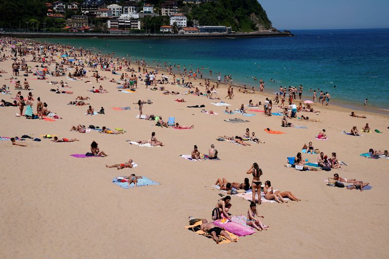 People sunbathe on Ondarreta beach, amid the coronavirus disease (COVID-19)