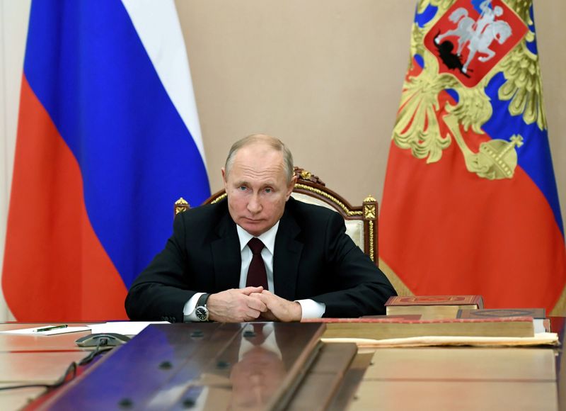 FILE PHOTO: Russian President Putin attends a meeting with heads