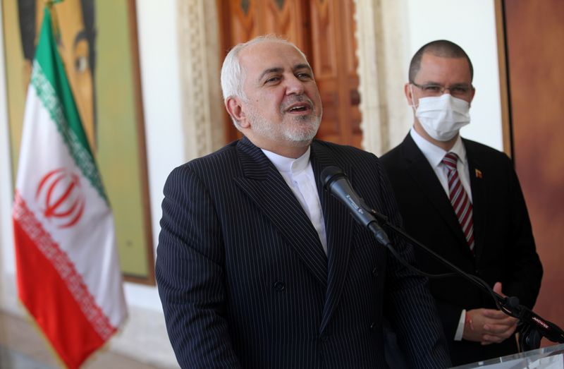 Iran’s Foreign Minister Mohammad Javad Zarif talks next to Venezuela’s