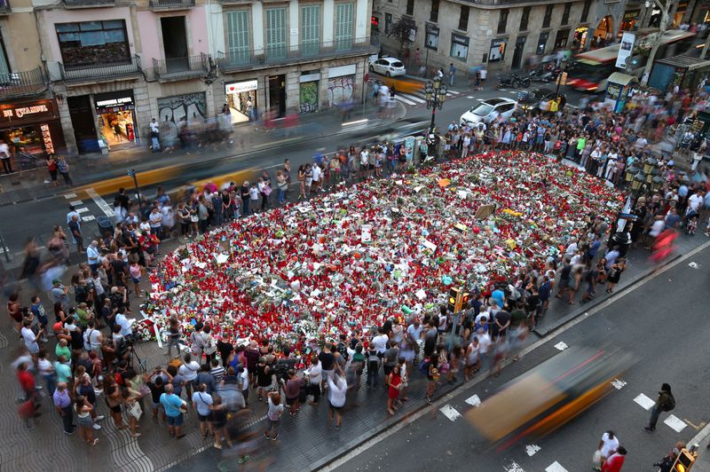 FILE PHOTO: People gather at an impromptu memorial in Barcelona