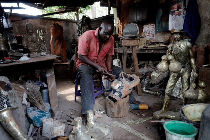 FILE PHOTO: Local bronze sculptor Eric Ogbemudia, 62, works in