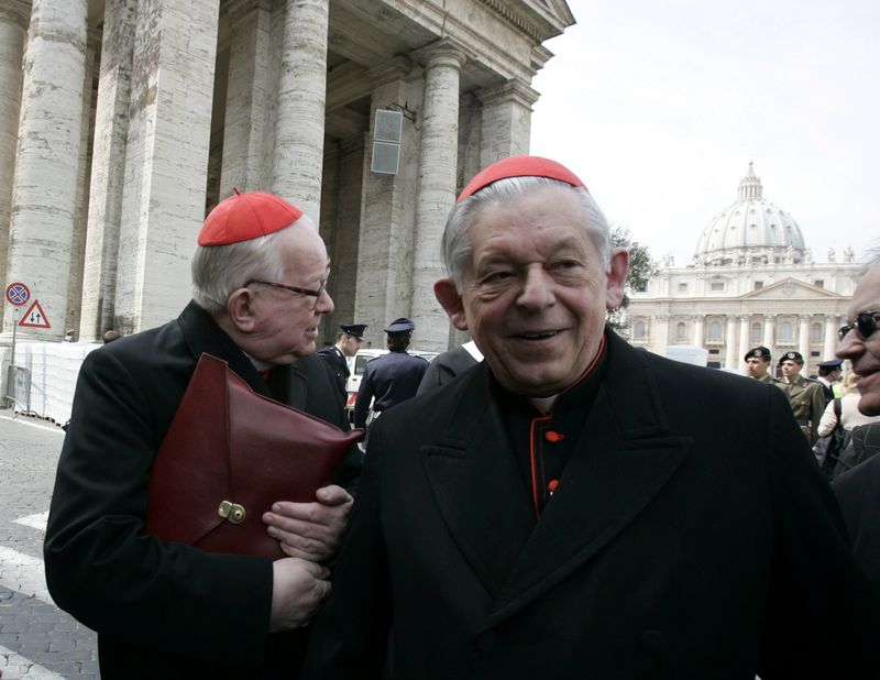 FILE PHOTO: Polish cardinals Glemp and Gulbinowicz walk through the
