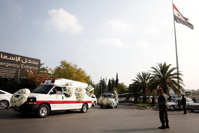 A vehicle transports the coffin of Syria’s Foreign Minister Walid