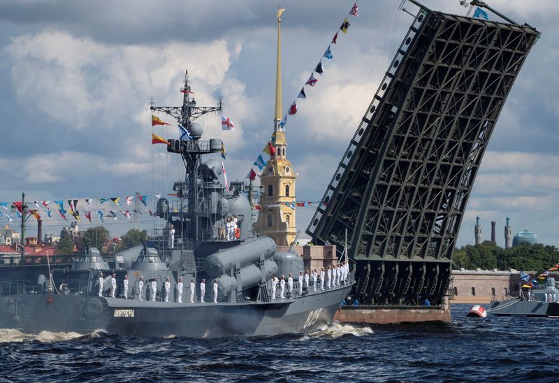 FILE PHOTO: A Russian warship sails past the Dvortsoviy Bridge