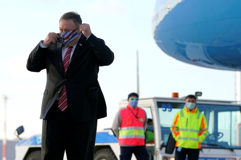 U.S. Secretary of State Mike Pompeo puts on a mask