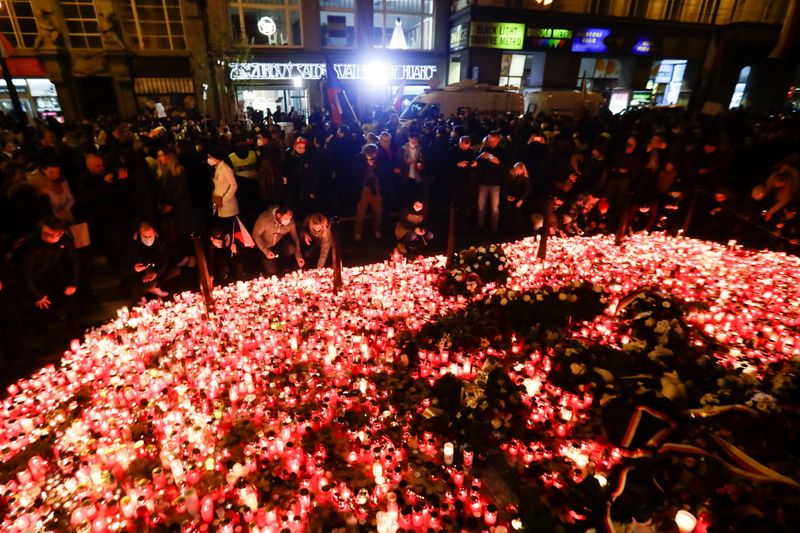 People light candles at the Velvet Revolution memorial