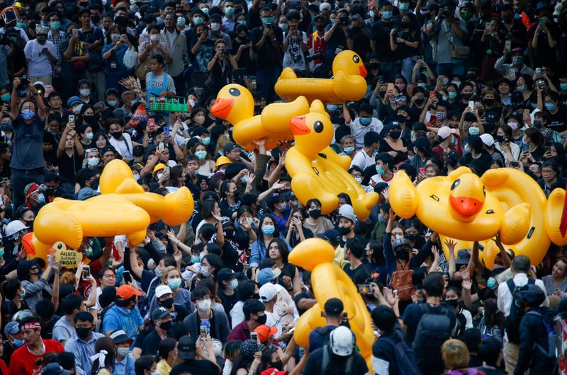Pro-democracy demonstrators move inflatable rubber ducks during a rally in