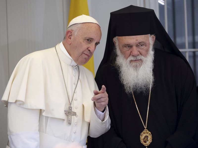 FILE PHOTO: Pope Francis gestures next to Archbishop Ieronymos II