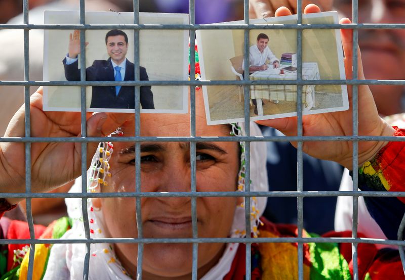 FILE PHOTO: A woman holds pictures of jailed former leader