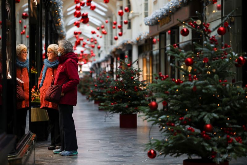 Women are seen at the Burlington Arcade adorned with Christmas