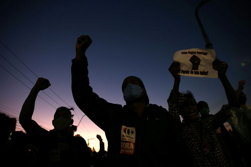 Demonstrators take part in a protest against racism, after Joao