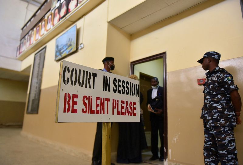 Police officers stand guard at a court during an appeal