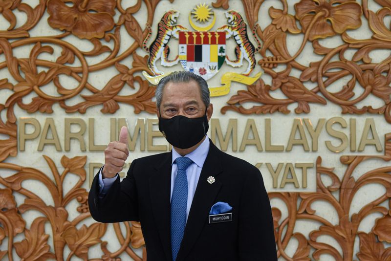 FILE PHOTO: Malaysia’s Prime Minister Muhyiddin Yassin poses for a