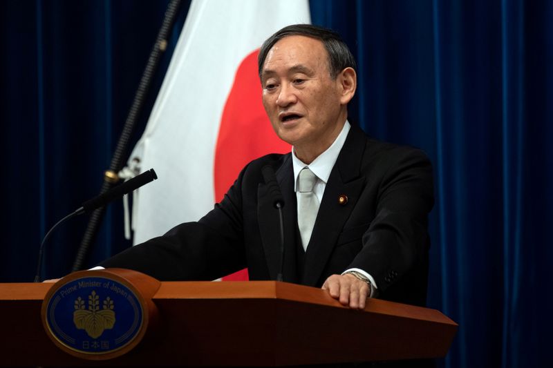 FILE PHOTO: Yoshihide Suga speaks during a news conference following