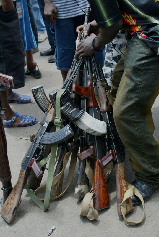 FILE PHOTO: LIBERIAN REBELS DISARM AT A CHECK POINT OUTSIDE