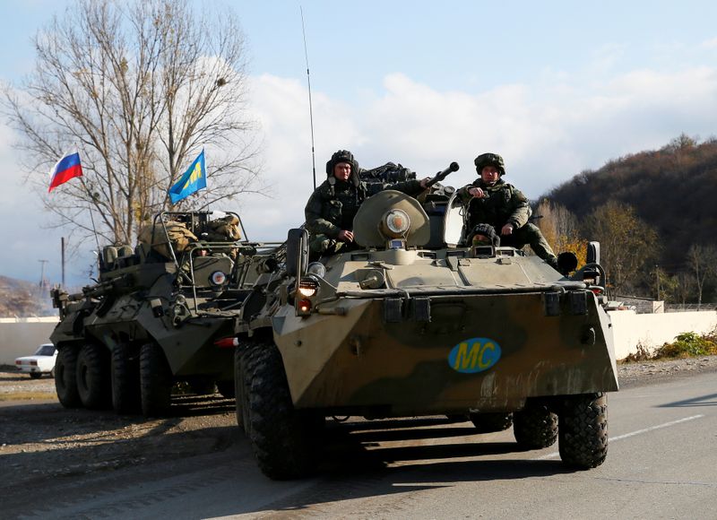 FILE PHOTO: Russian peacekeepers drive near Arutyunagomer, in the region