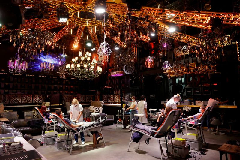People give blood on the stage of the closed MAD