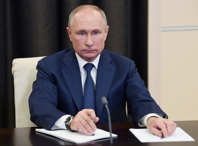 FILE PHOTO: Russian President Putin attends a conference via a