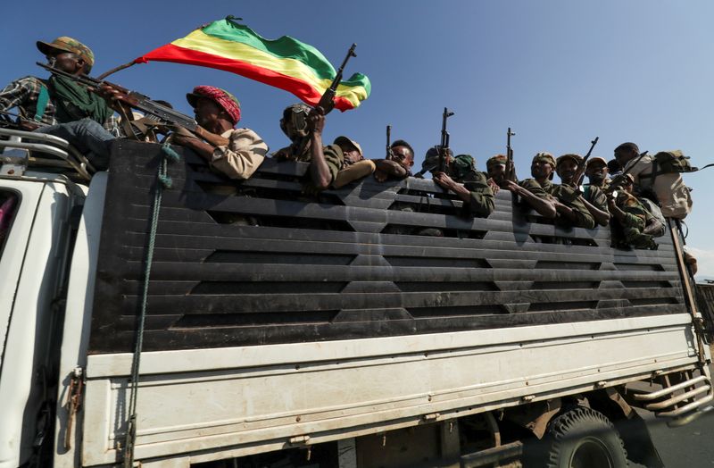 FILE PHOTO: Members of Amhara region militias ride on their