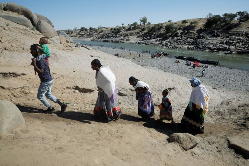 FILE PHOTO: Ethiopians who have just crossed a river from