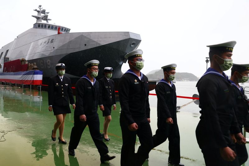 Navy officers march during the official ceremony for the new